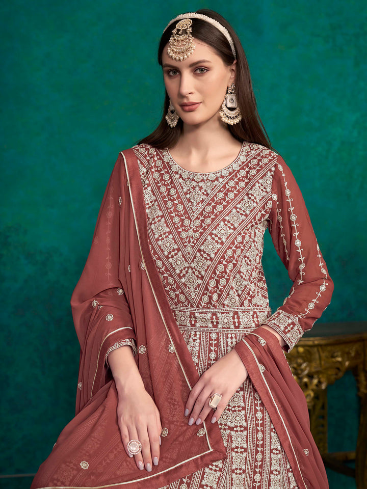 Elegant brick brown salwar kameez made from faux georgette, showcasing intricate embroidery and sequins for elegant celebrations.