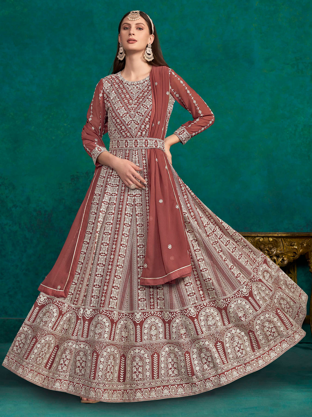 Rich brick brown faux georgette salwar kameez featuring exquisite heavy thread embroidery and sequins, perfect for special occasions.