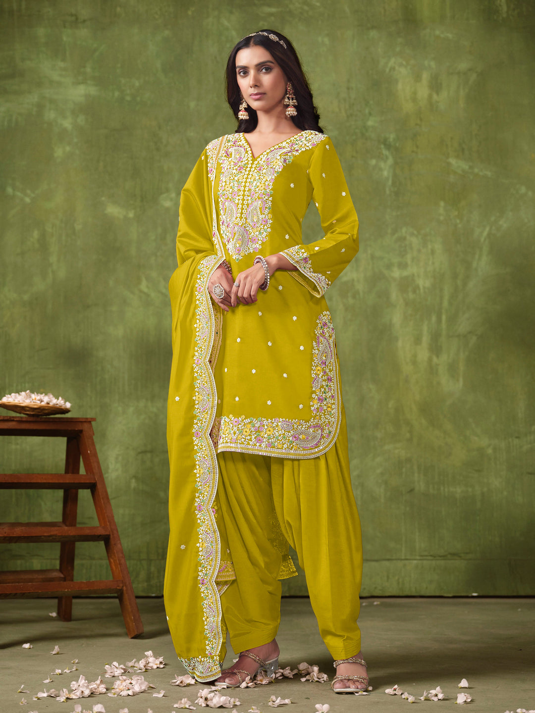 Vibrant mustard salwar kameez in Roman silk adorned with beautiful heavy thread embroidery and shimmering sequins for celebrations.