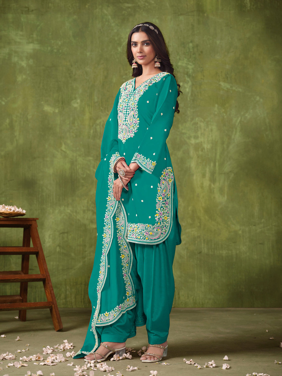 Chic teal Roman silk salwar kameez showcasing exquisite heavy thread embroidery and sequins, ideal for weddings and parties.