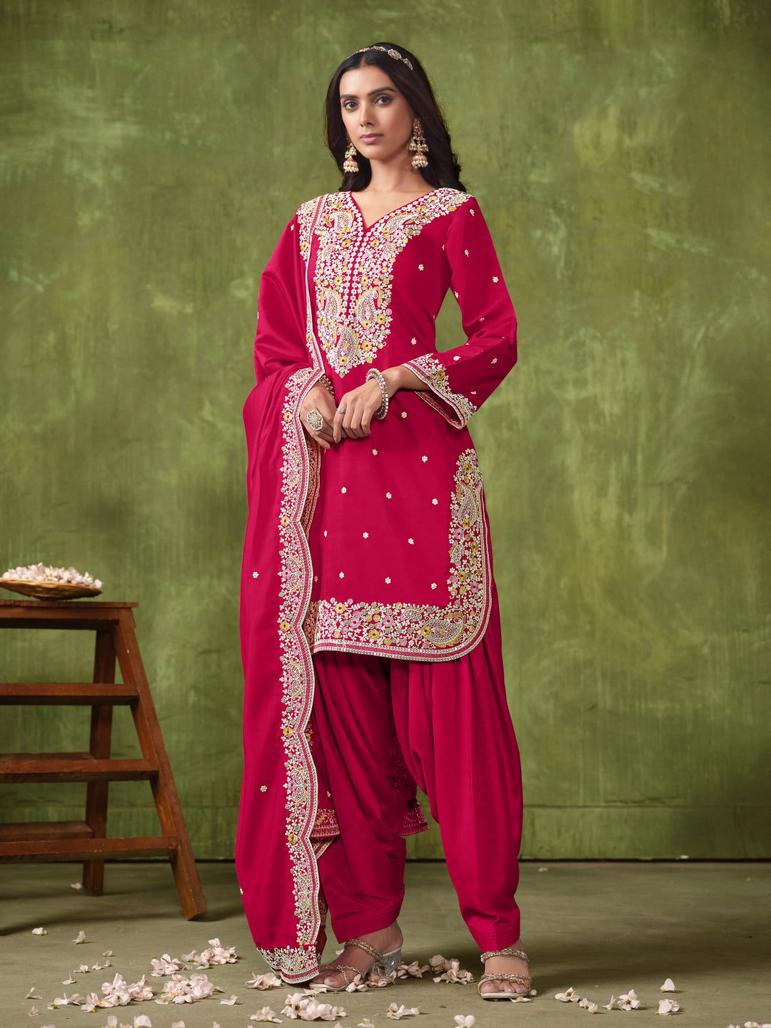 Stunning rani pink Roman silk salwar kameez adorned with intricate heavy thread embroidery and sequins, ideal for festive wear.