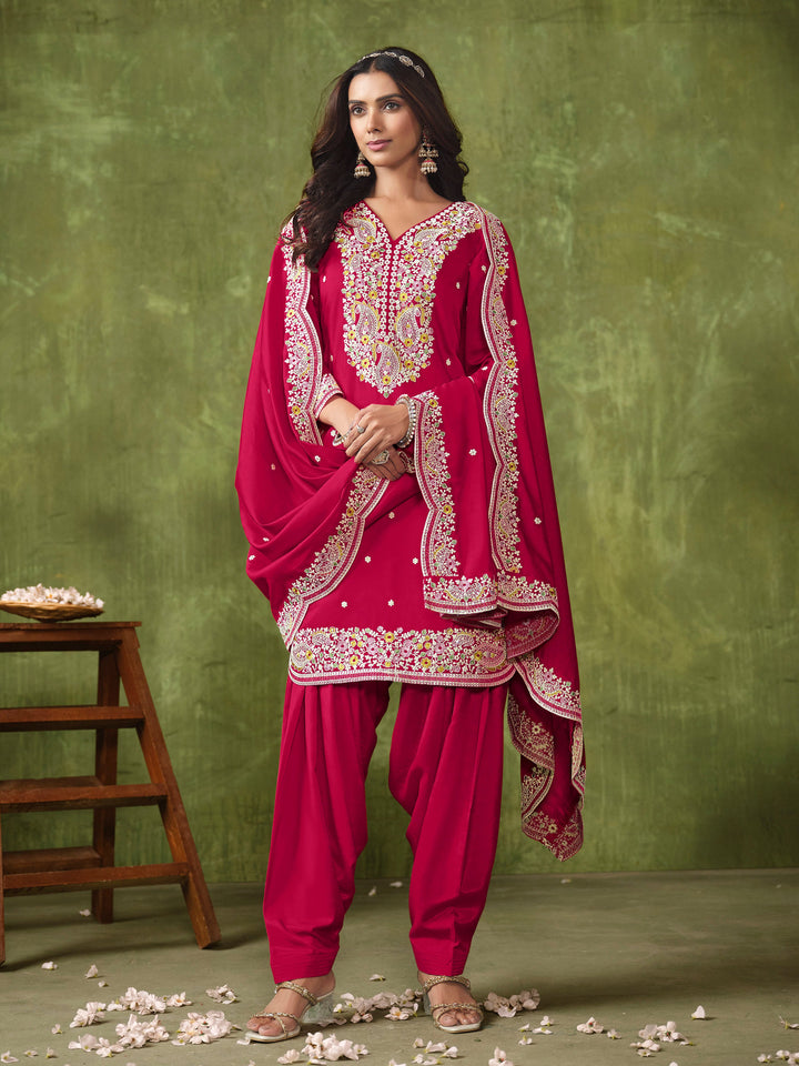 Elegant rani pink Roman silk salwar kameez featuring exquisite heavy thread embroidery and sequins, perfect for special occasions.