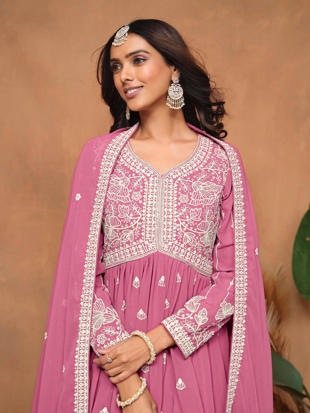 Elegant pink faux georgette salwar kameez showcasing heavy thread embroidery and sharara bottom, perfect for weddings and parties.