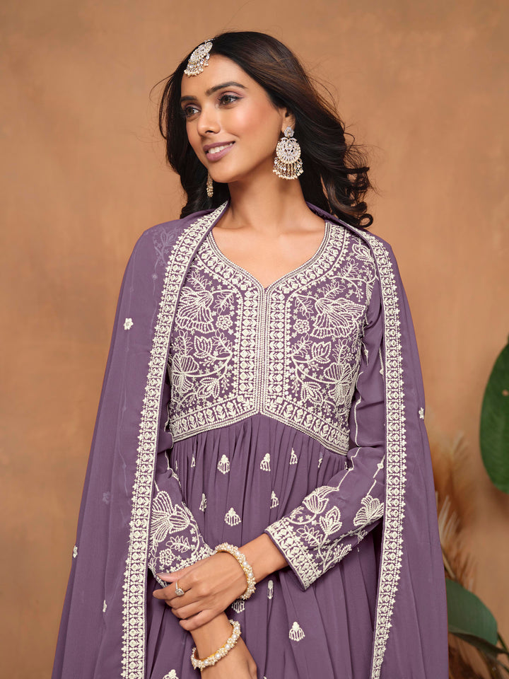 Beautiful purple faux georgette salwar kameez with exquisite heavy thread embroidery and sharara bottom, perfect for cultural events.