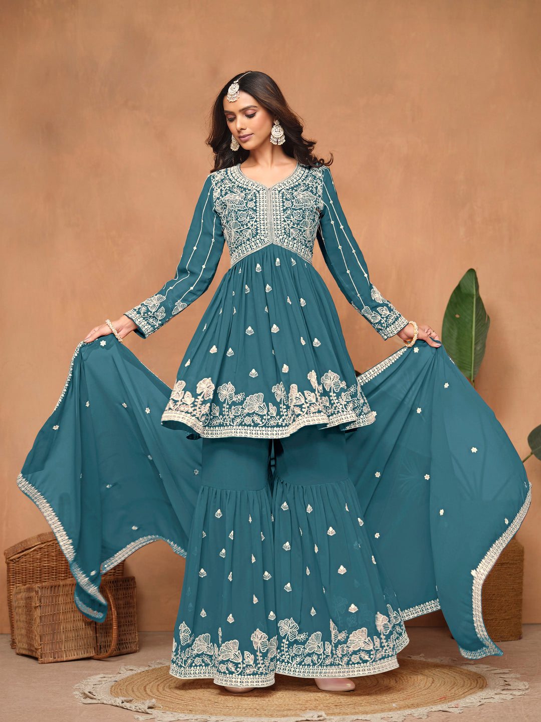 Beautiful teal blue faux georgette salwar kameez with exquisite heavy thread embroidery and free size sharara bottom, ideal for weddings.