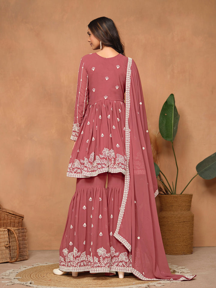 Beautiful dark rose faux georgette salwar kameez showcasing heavy thread embroidery and a flowing sharara bottom for special events.