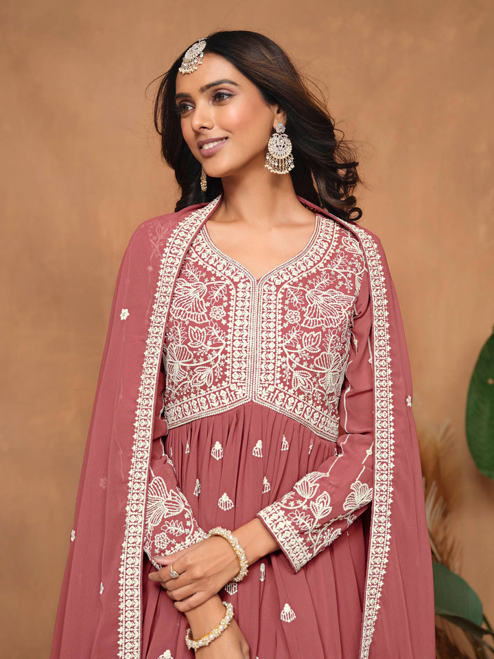 Vibrant dark rose faux georgette salwar kameez with intricate heavy thread embroidery and sharara bottom, perfect for celebrations.