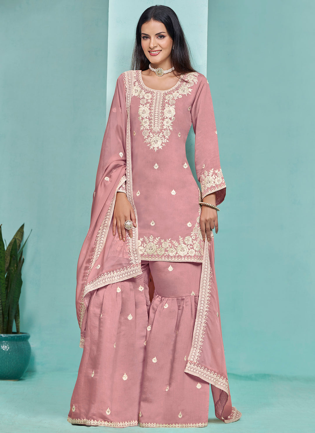 Elegant baby pink Roman silk salwar kameez featuring heavy thread embroidery and sequins work, perfect for special occasions.