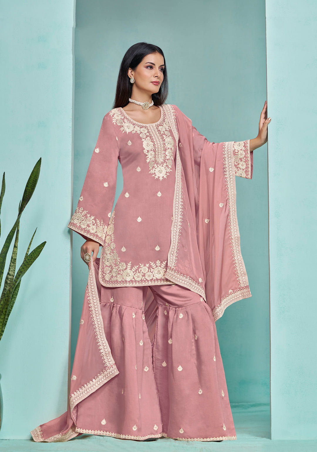 Beautiful baby pink Roman silk salwar kameez showcasing intricate heavy thread embroidery and sequins, ideal for festive celebrations.