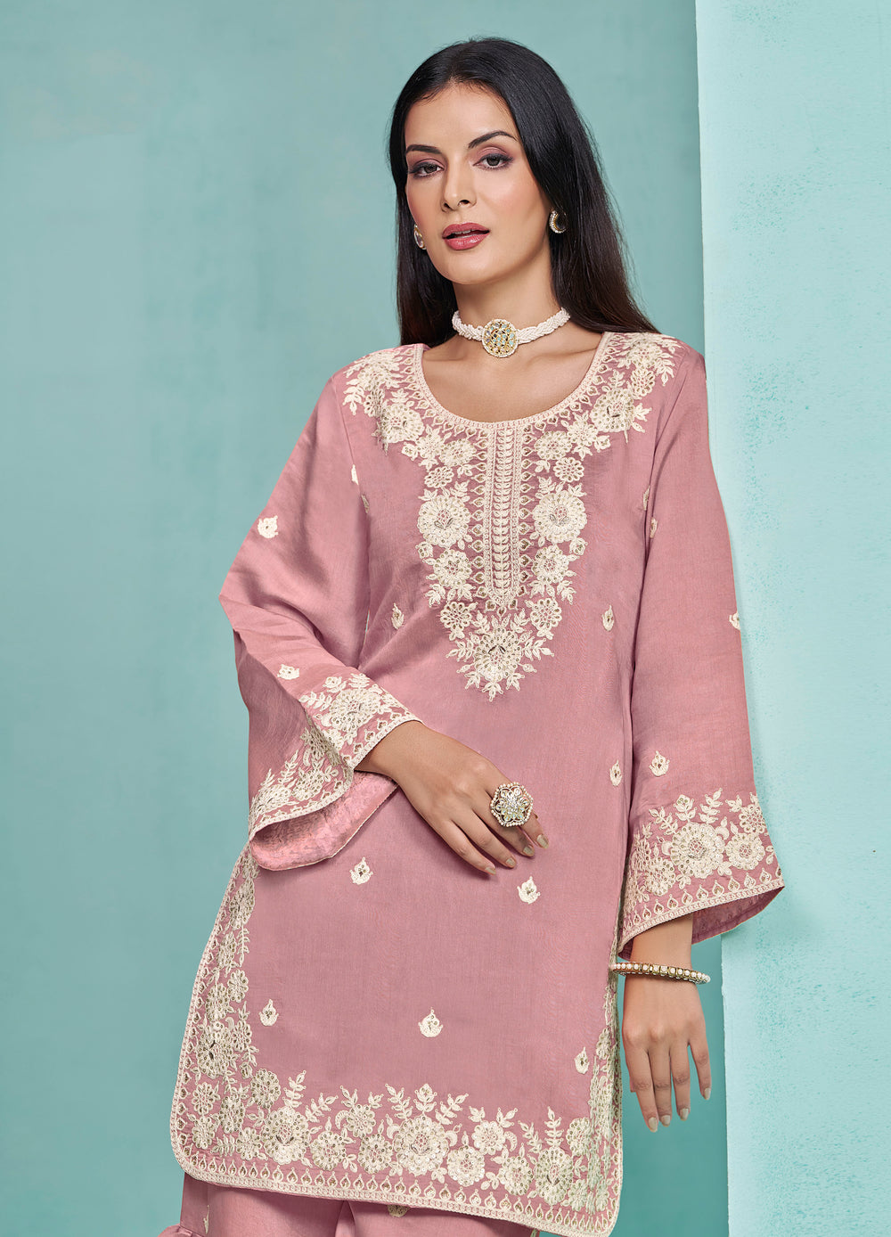 Stunning baby pink Roman silk salwar kameez with exquisite heavy thread embroidery and sequins, designed with a sharara bottom.