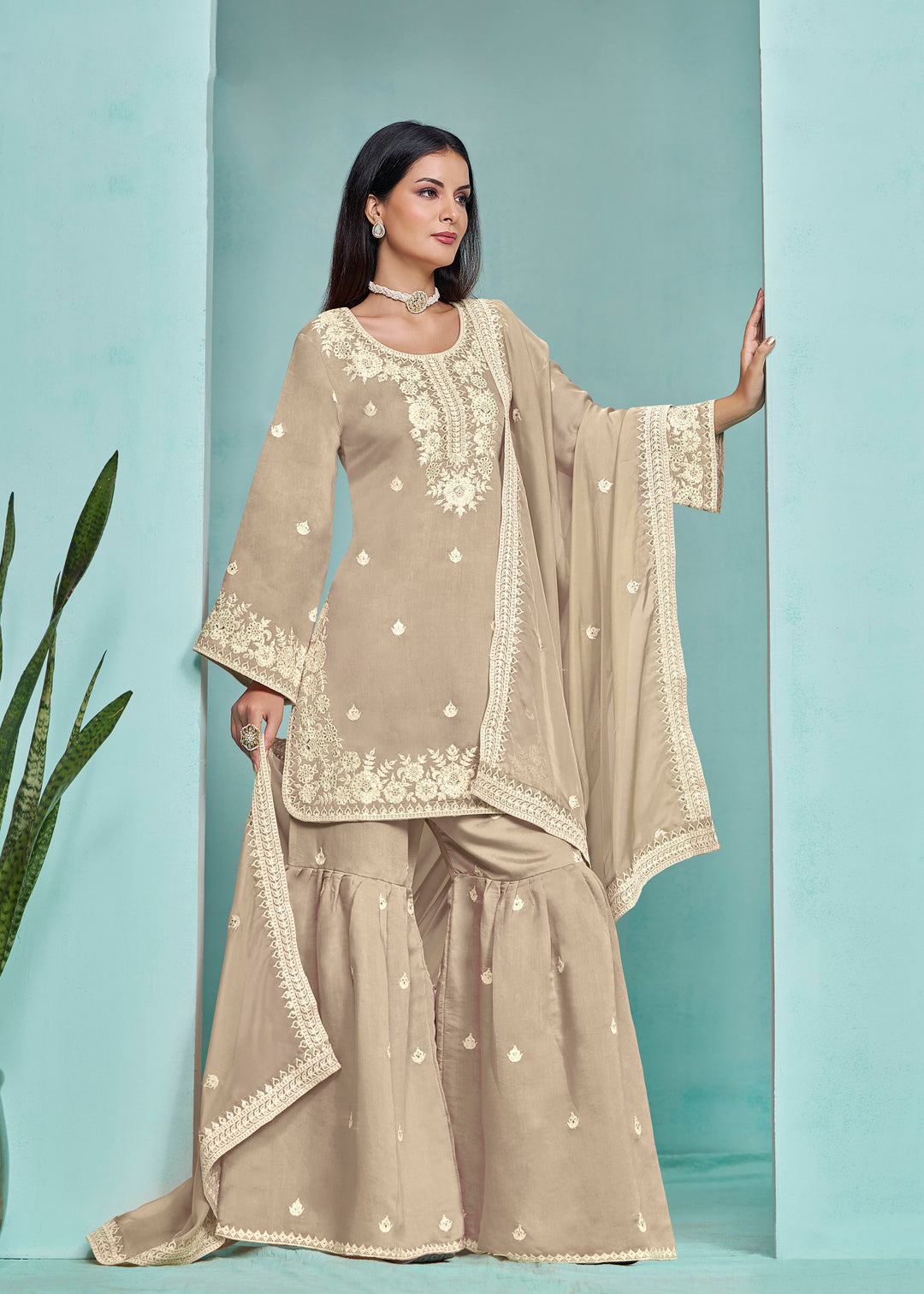 Beautiful beige Roman silk salwar kameez showcasing exquisite heavy thread embroidery and sequins, ideal for festive occasions.