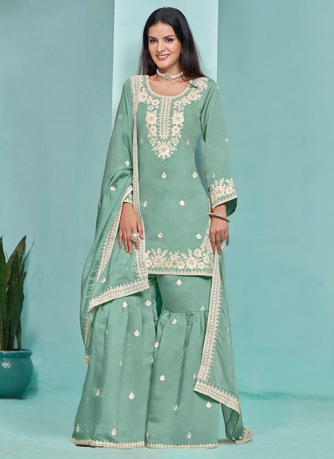 Elegant light green Roman silk salwar kameez adorned with exquisite heavy thread embroidery and sequins, designed with a sharara bottom.