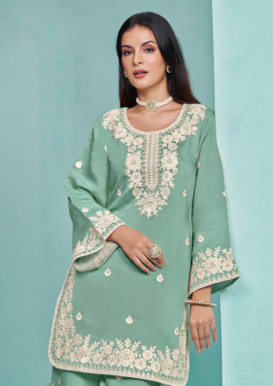 Gorgeous light green Roman silk salwar kameez featuring heavy thread embroidery and sequins work, ideal for festive occasions.