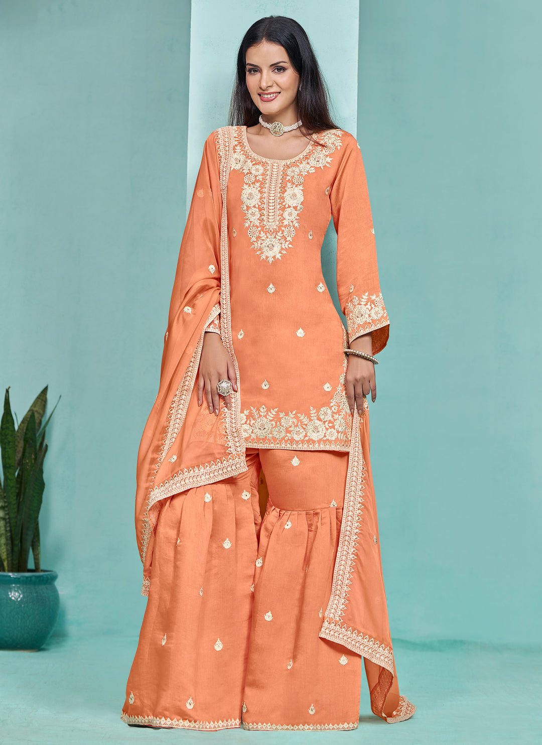 Stunning light orange Roman silk salwar kameez featuring intricate heavy thread embroidery and sequins work, perfect for celebrations.