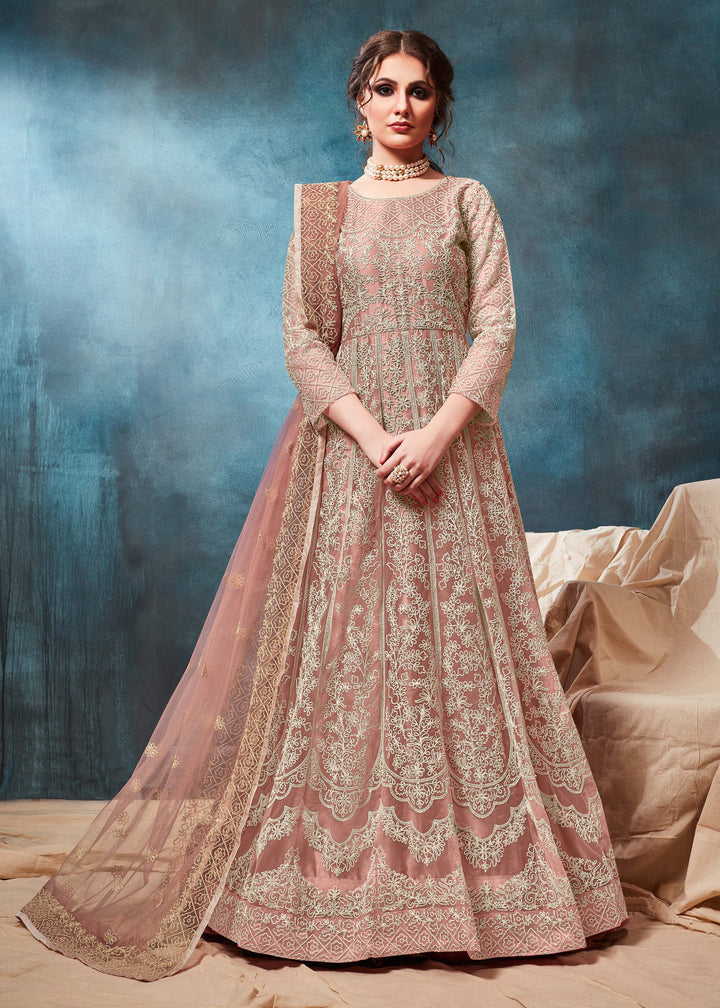 Stunning peach traditional salwar kameez, perfect for special gatherings, featuring elegant embroidery and stylish design.