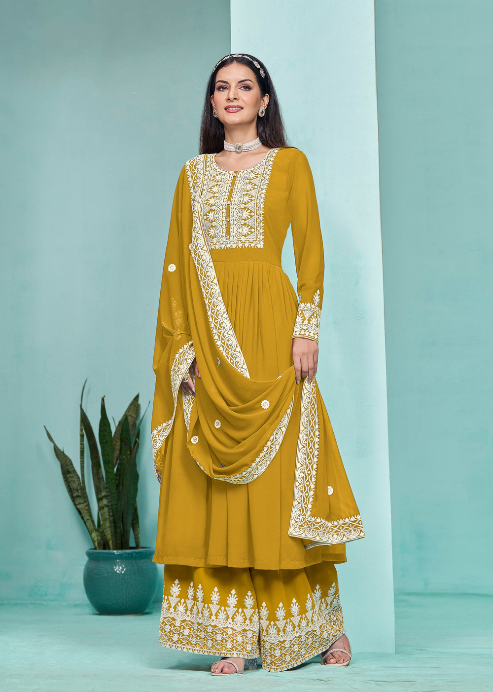 Stunning mustard faux georgette salwar kameez adorned with intricate heavy thread embroidery and sequins, perfect for festive occasions.