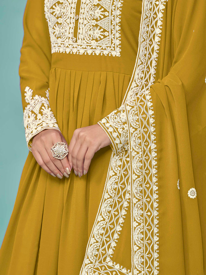 Chic mustard faux georgette salwar kameez with stunning heavy thread embroidery and sequins, great for cultural events.