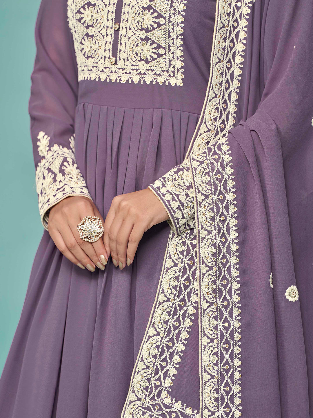 Chic purple faux georgette salwar kameez with stunning heavy thread embroidery and sequins, great for cultural celebrations.