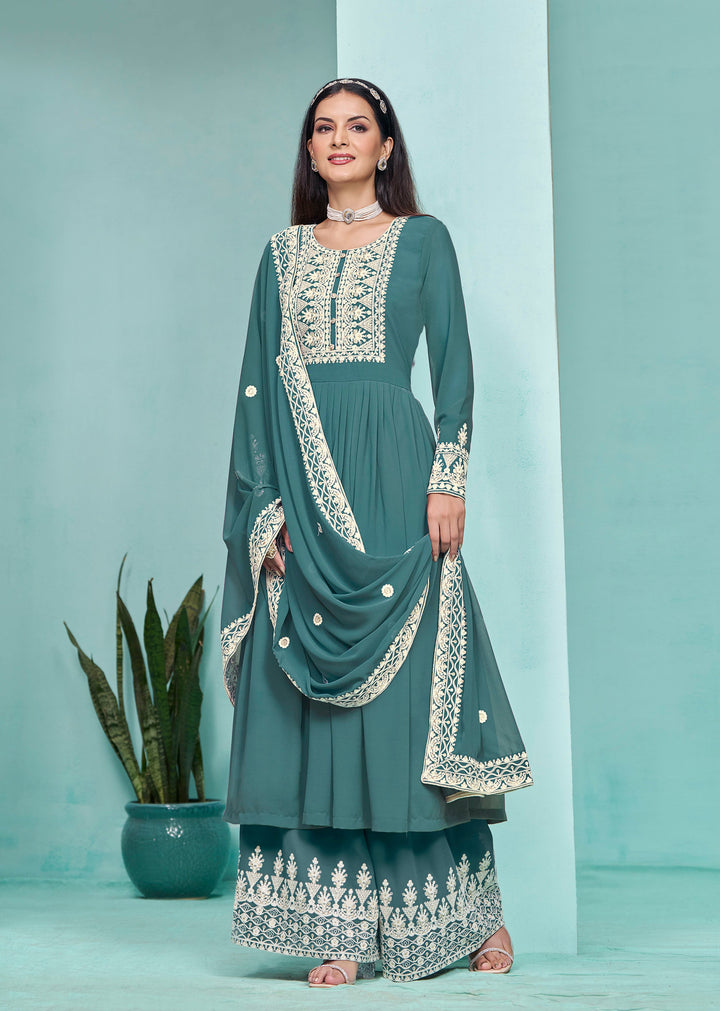 Elegant teal faux georgette salwar kameez adorned with intricate heavy thread embroidery and sequins, perfect for special occasions.