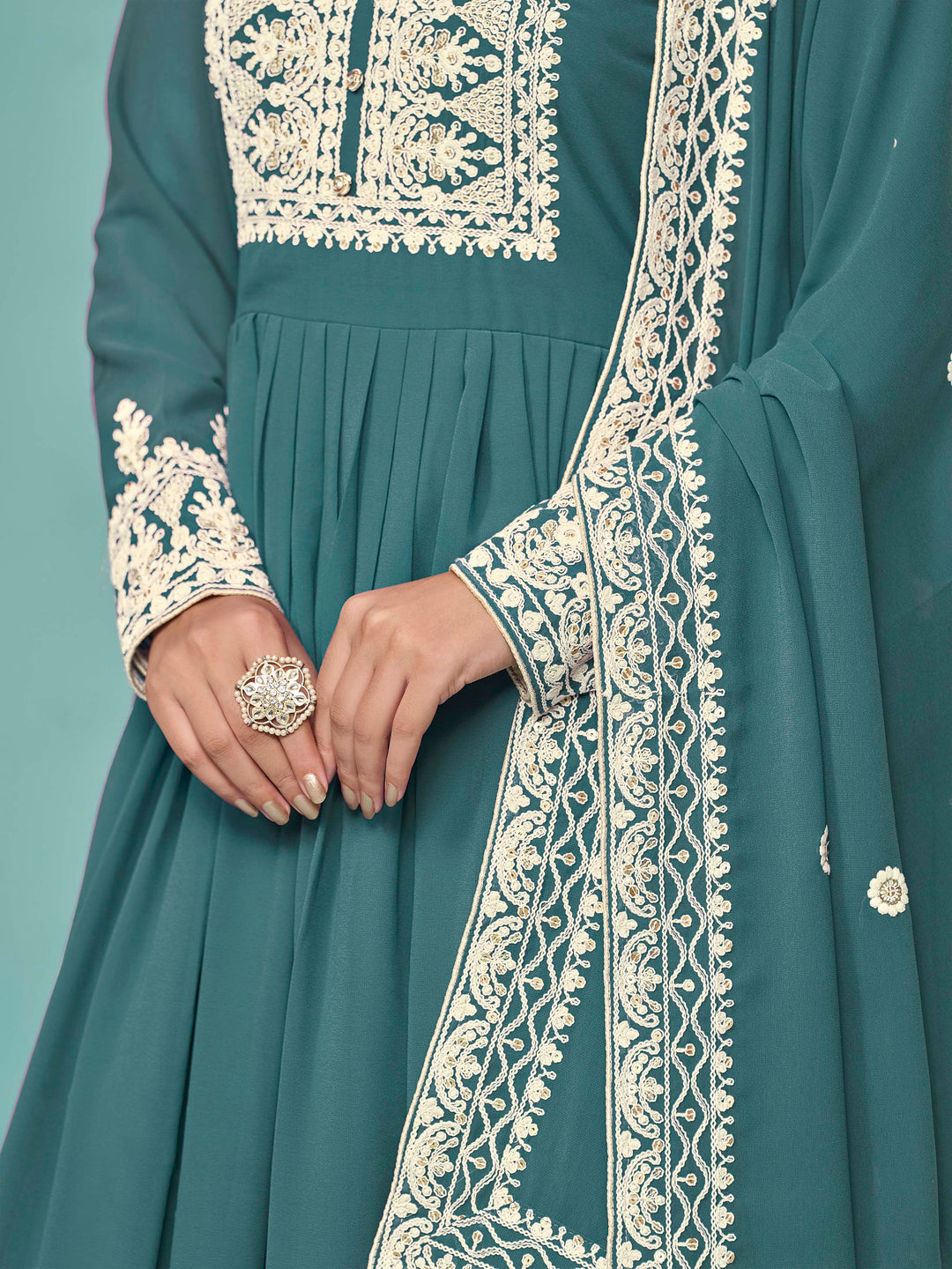 Charming teal faux georgette salwar kameez with stunning heavy thread embroidery and sequins, great for festive celebrations.