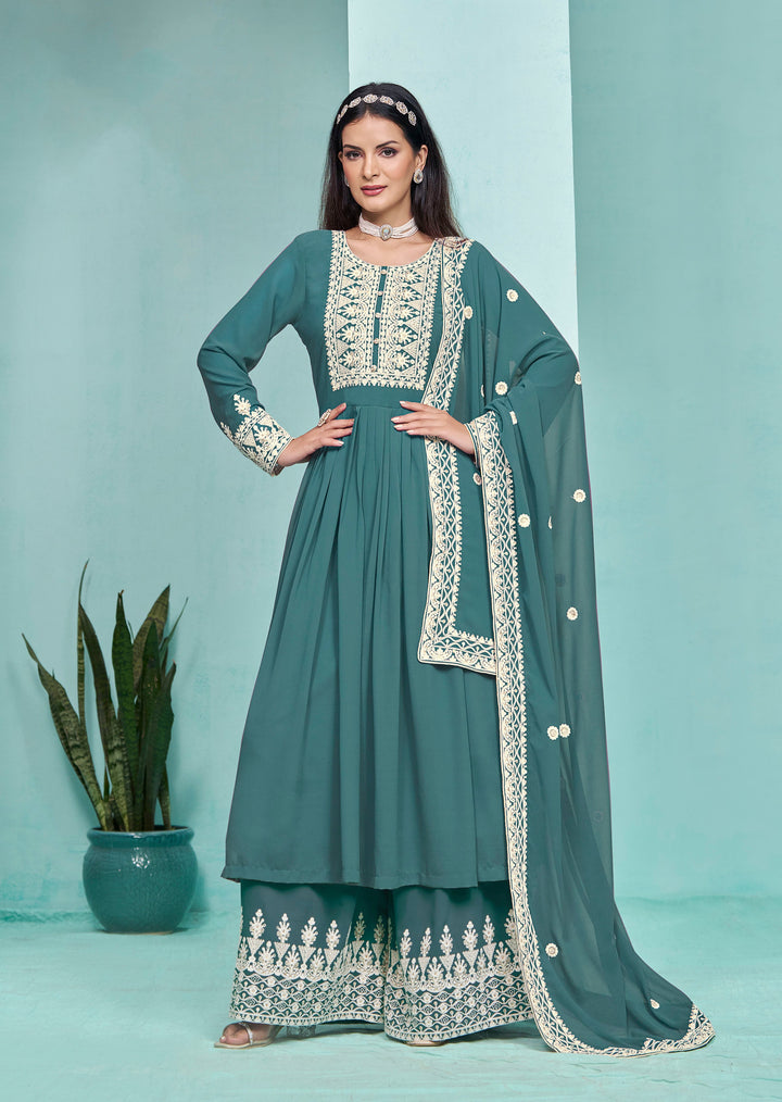 Stunning teal faux georgette salwar kameez featuring heavy thread embroidery and sequins work, designed with palazzo bottom for a chic look.