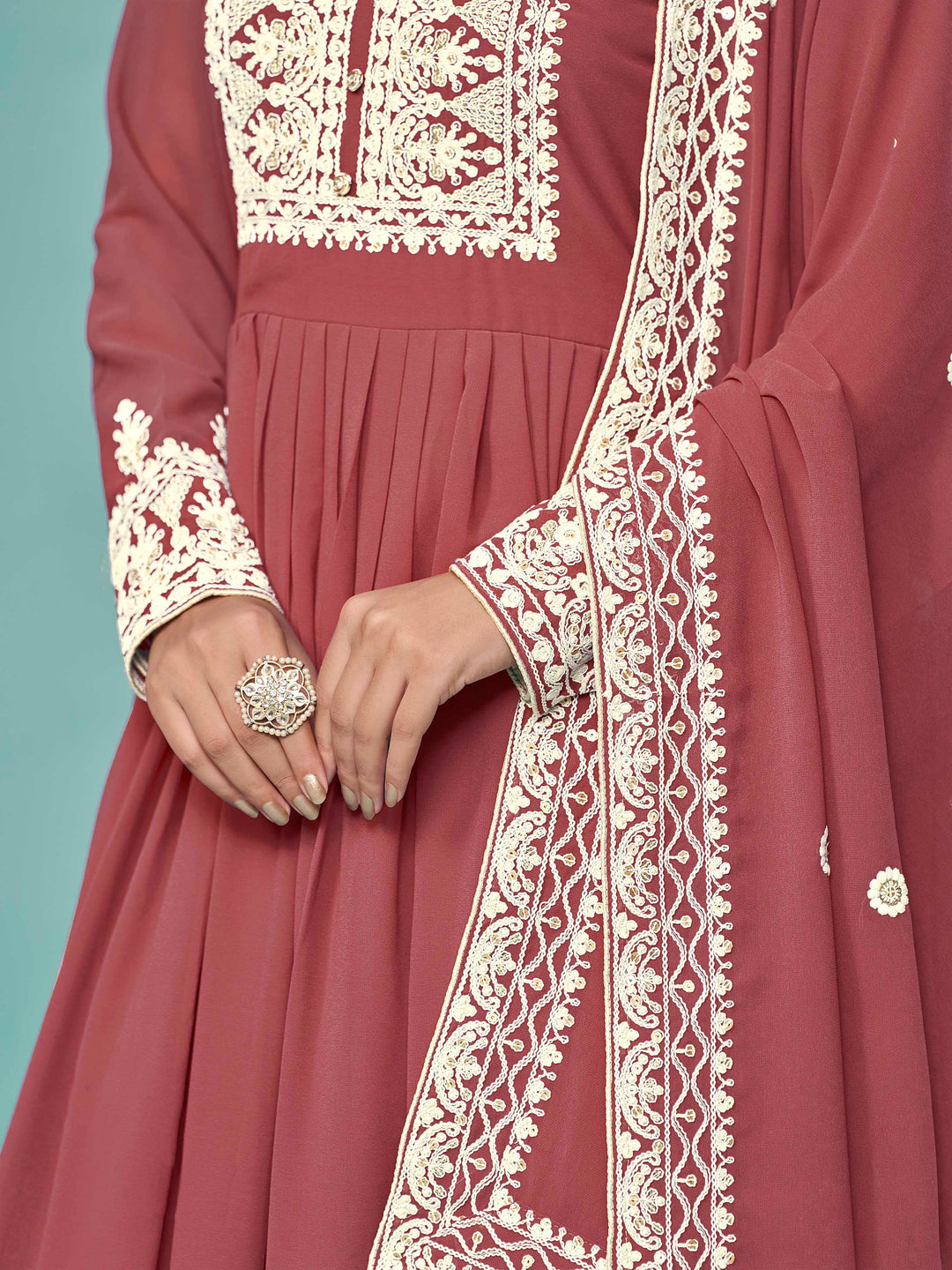 Chic brick faux georgette salwar kameez with stunning heavy thread embroidery and sequins, great for cultural events.