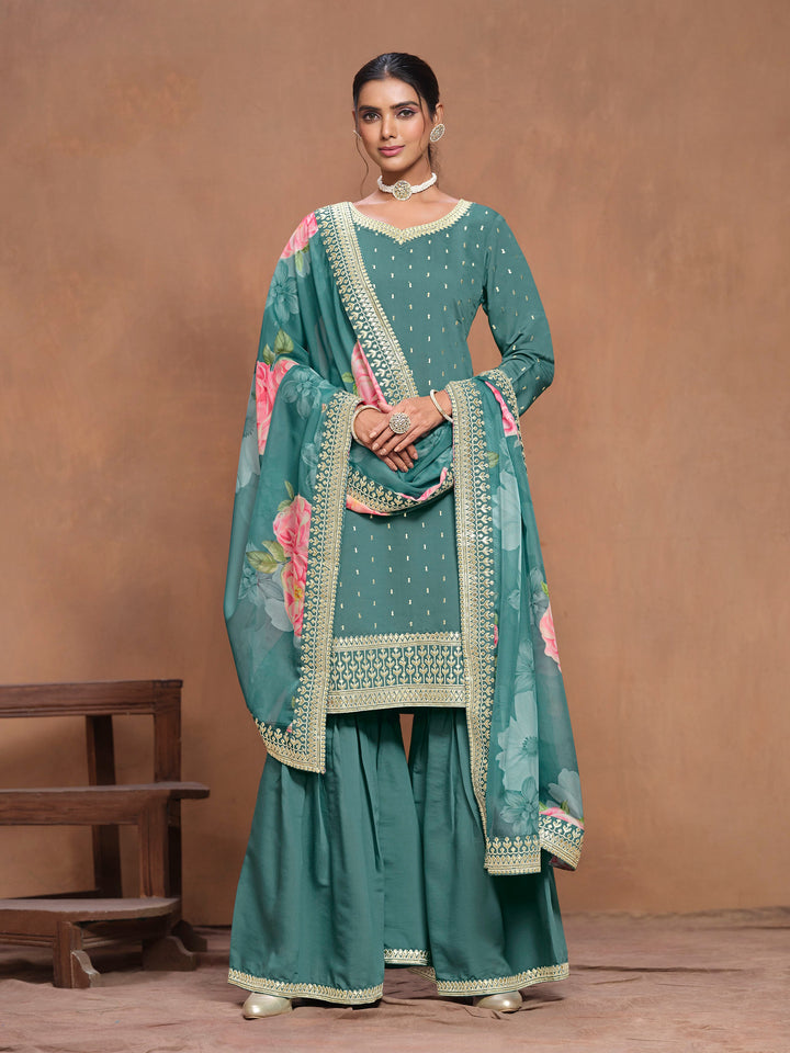 Stunning teal Roman silk salwar kameez adorned with heavy thread embroidery and a vibrant printed dupatta, perfect for special occasions.