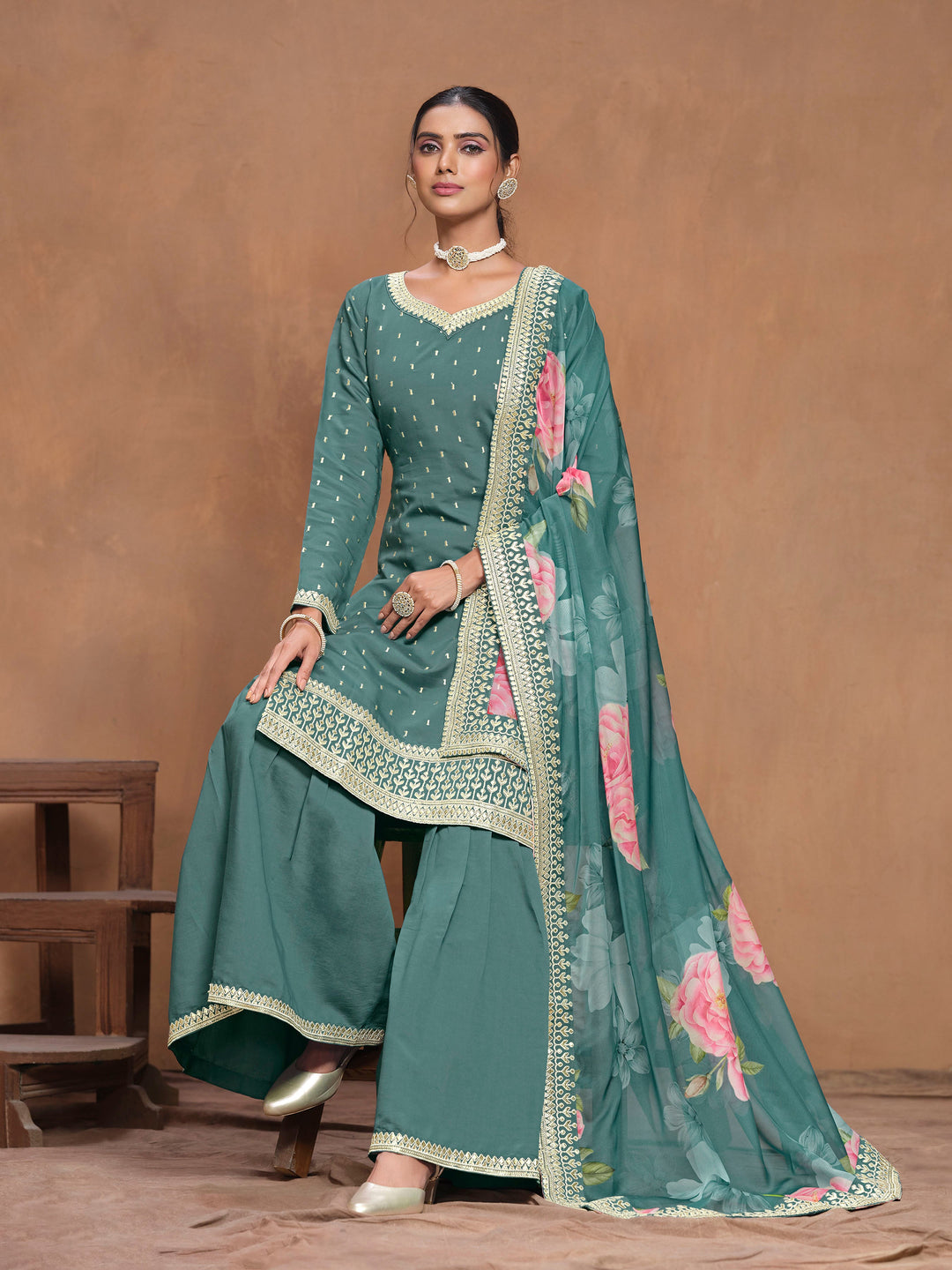 Elegant teal Roman silk salwar kameez showcasing exquisite heavy thread embroidery and a printed dupatta, ideal for weddings.