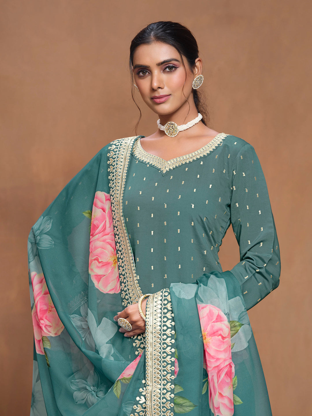 Charming teal Roman silk salwar kameez with stunning heavy thread embroidery and a beautiful printed dupatta, great for cultural celebrations.