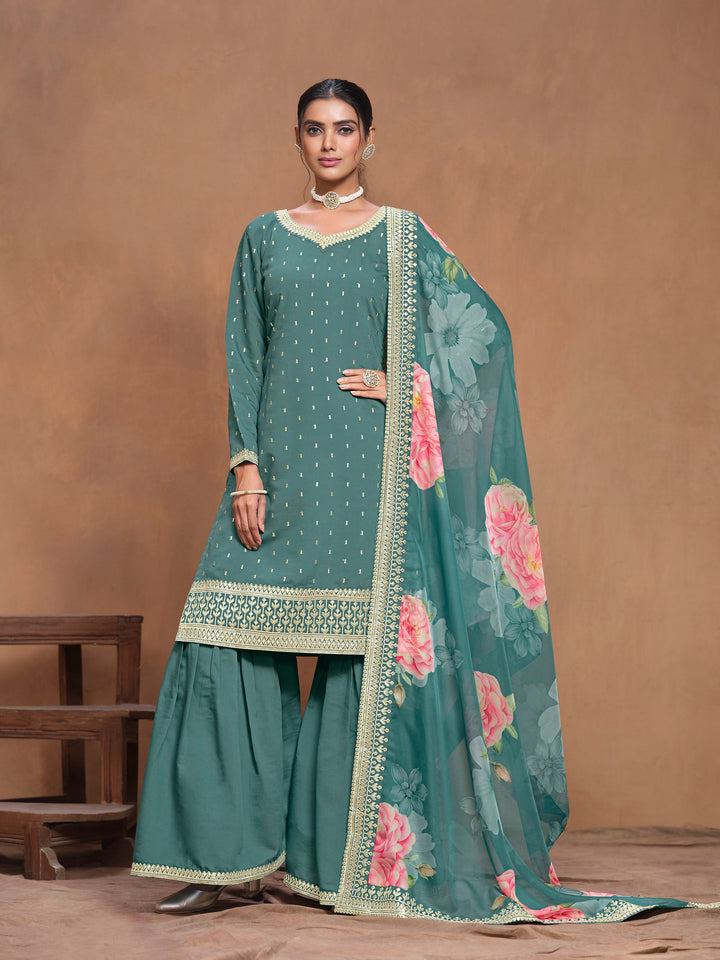 Gorgeous teal Roman silk salwar kameez featuring intricate heavy thread embroidery and a printed dupatta, designed with palazzo bottom.