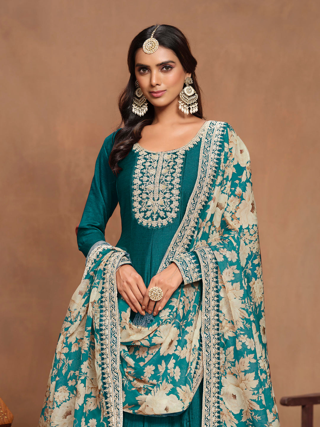 Chic teal art silk salwar kameez with intricate heavy thread embroidery and sequins, designed to impress at cultural events.