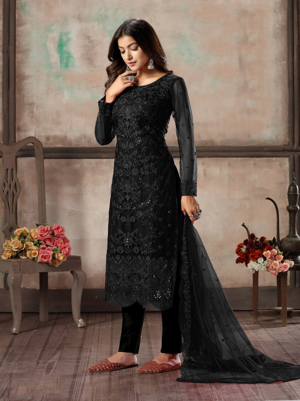 Women's black salwar kameez set with luxurious design for special events.