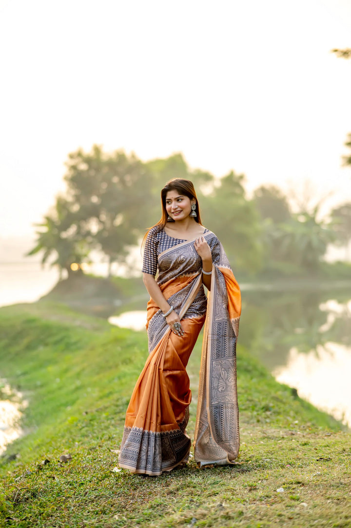 Deep yellow soft tussar silk saree with vibrant Madhubani prints and delicate tassels, perfect for festive occasions.