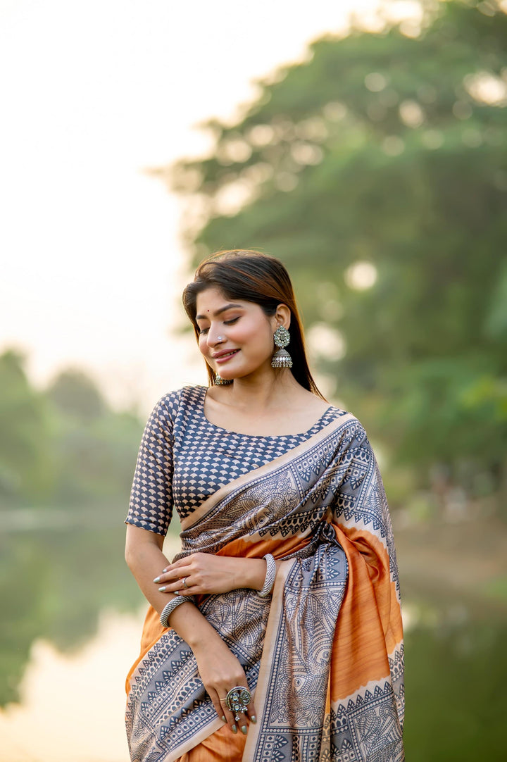 Elegant deep yellow soft tussar silk saree with beautiful Madhubani prints and stylish tassels, perfect for cultural events.