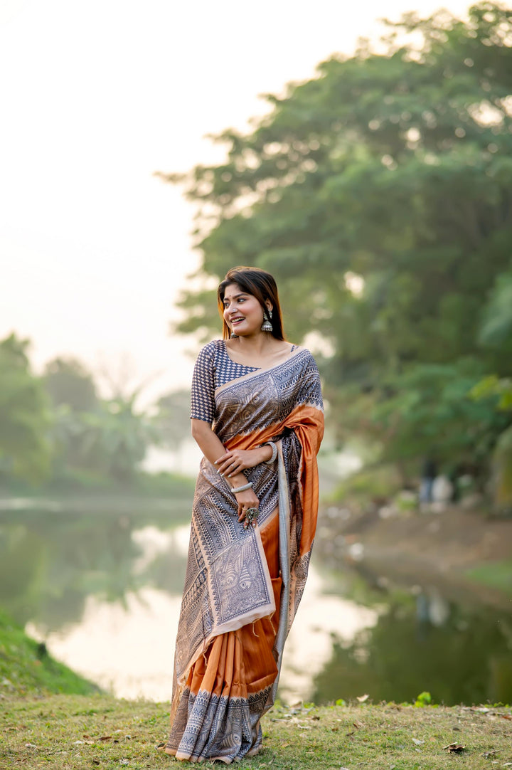 Rich deep yellow soft tussar silk saree with traditional Madhubani prints and playful tassels, ideal for celebrations.