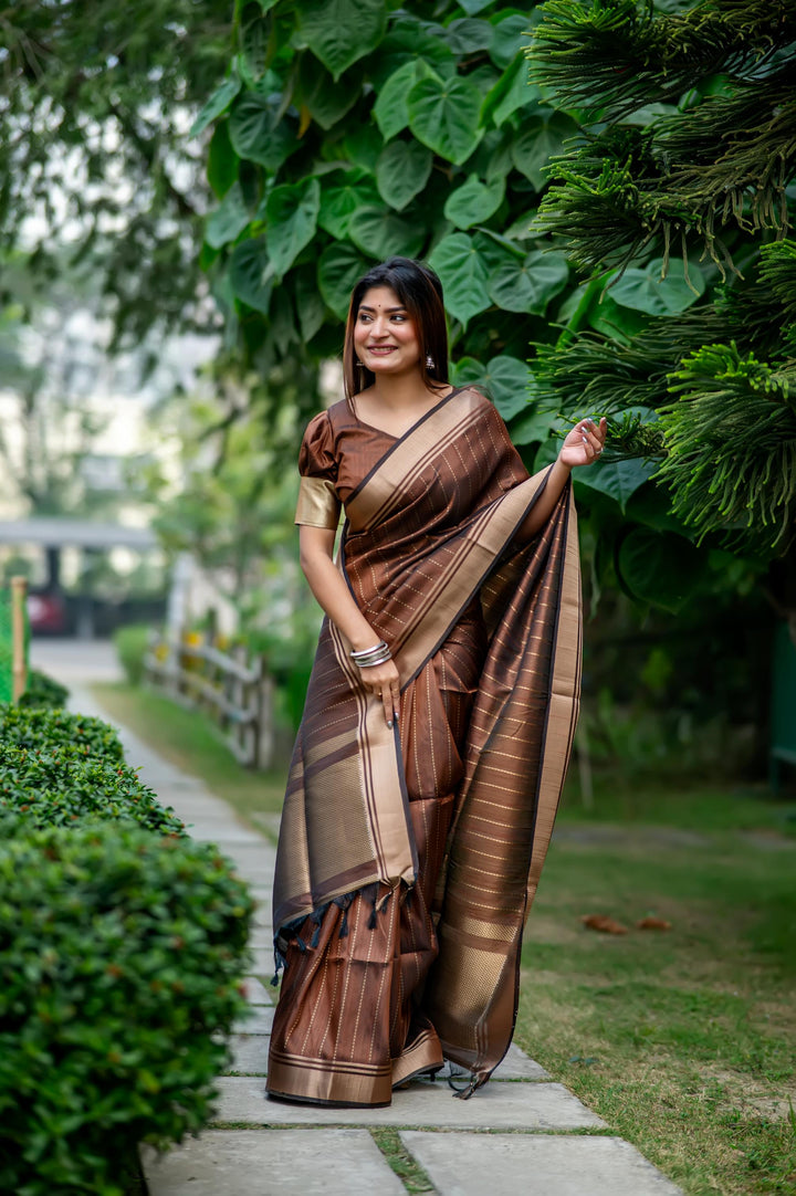 Gorgeous brown Banarasi saree with rich zari weaving, perfect for adding elegance to any special occasion.