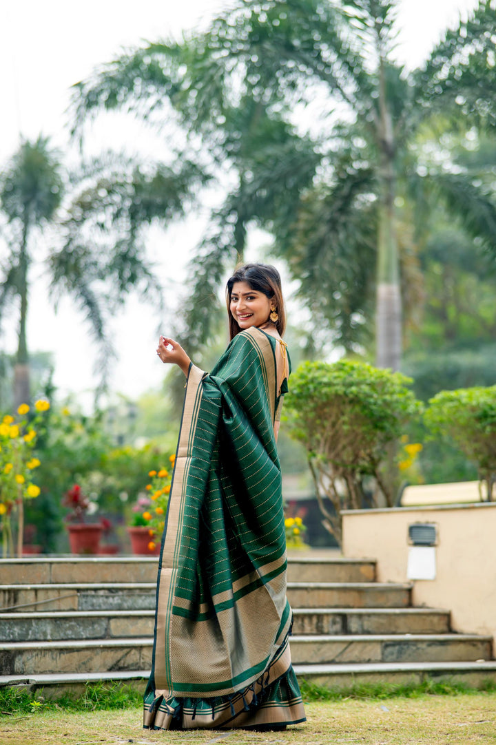 Elegant dark-green Banarasi saree with rich zari weaving, perfect for adding sophistication to cultural events.