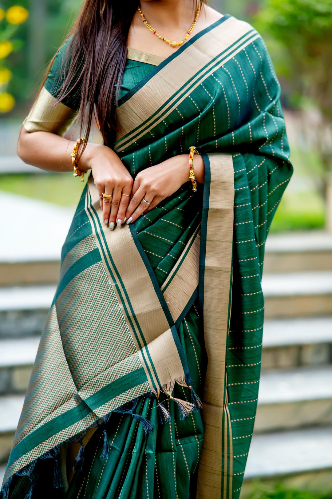 Timeless dark-green Banarasi saree with exquisite zari pattern, perfect for festive celebrations and weddings.