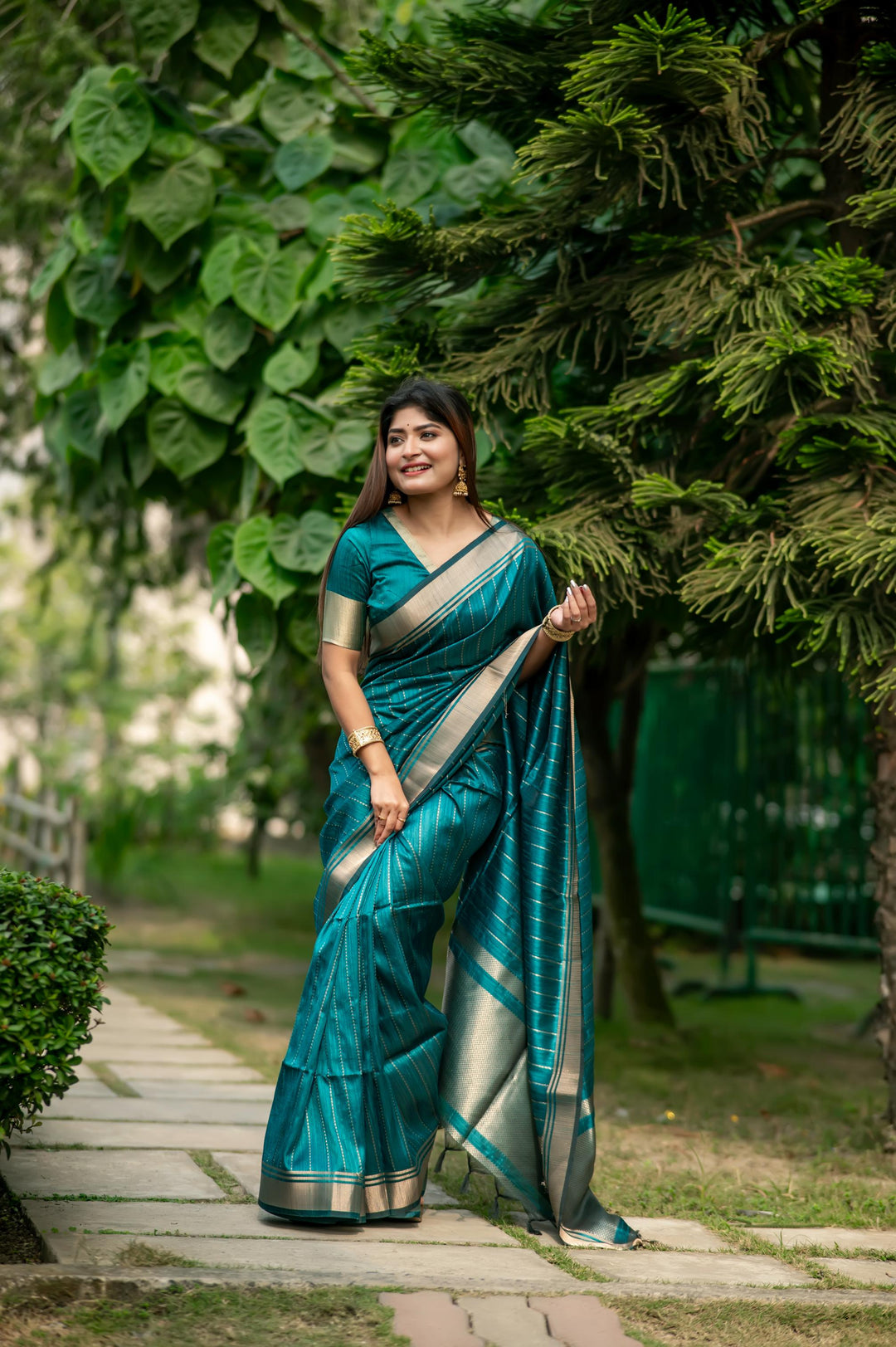 Elegant sea-blue Banarasi saree with intricate zari pattern, perfect for festive occasions and cultural events.