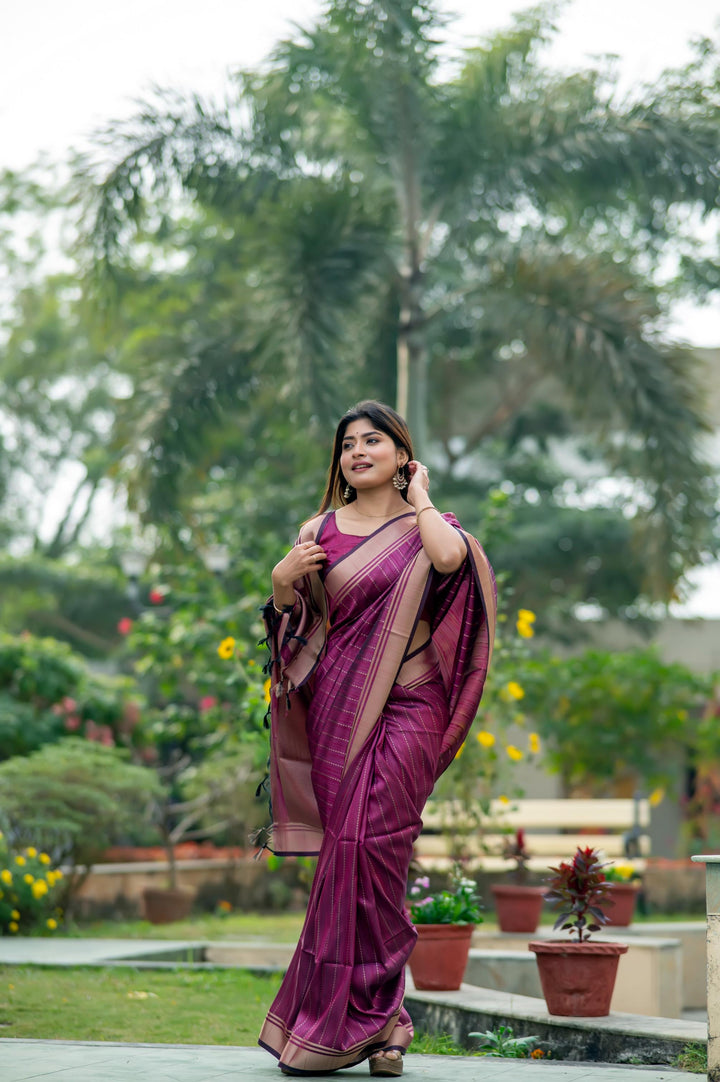 Exquisite dark-purple Banarasi saree with beautiful zari work, perfect for traditional and festive celebrations.