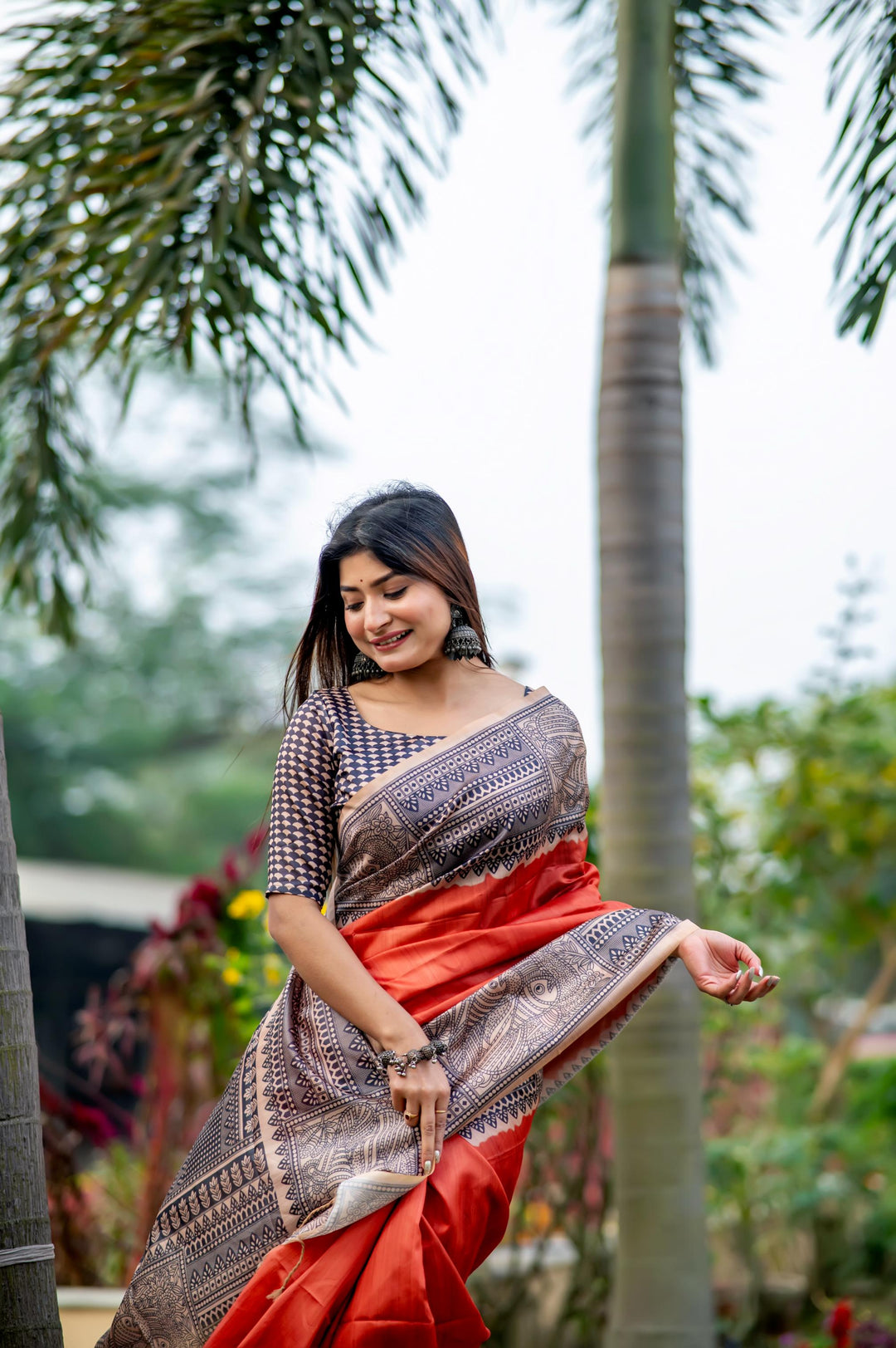 Rich red soft tussar silk saree with beautiful Madhubani prints and stylish tassels, ideal for cultural celebrations.