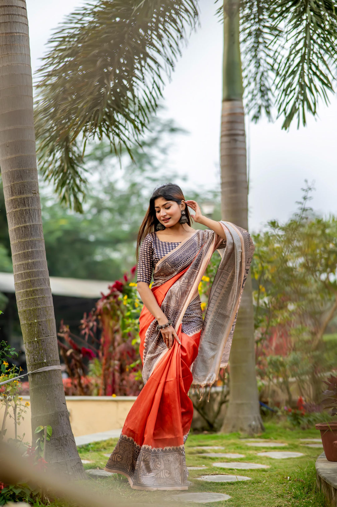 Elegant red soft tussar silk saree with intricate Madhubani prints and playful tassels, perfect for weddings.