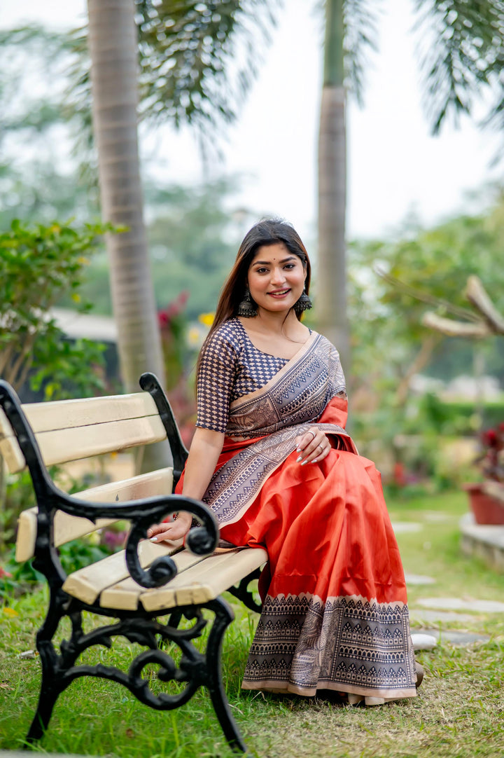 Beautiful red soft tussar silk saree with Madhubani prints and delicate tassels, ideal for traditional ceremonies.