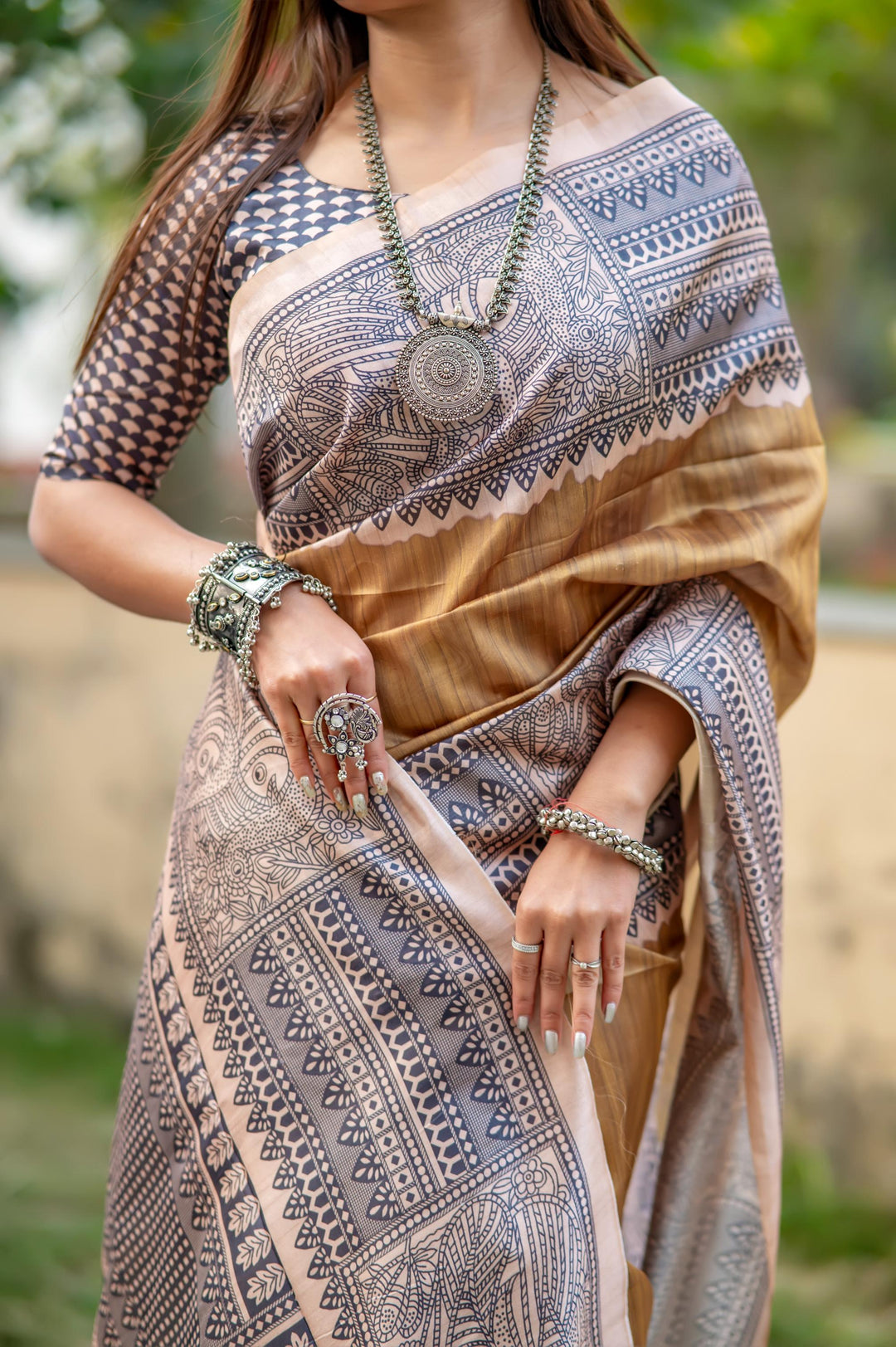 Bold fiery orange soft tussar silk saree featuring intricate Madhubani prints and chic tassels, ideal for festivals.