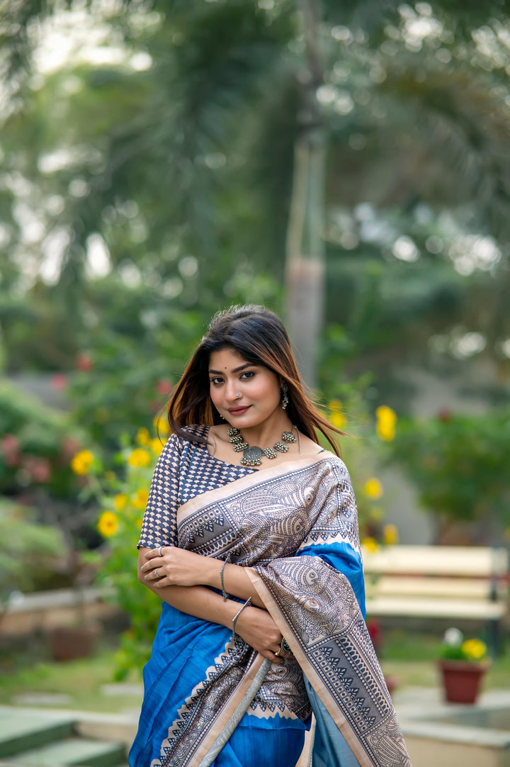 Beautiful fiery orange soft tussar silk saree with Madhubani prints and delicate tassels, perfect for weddings.