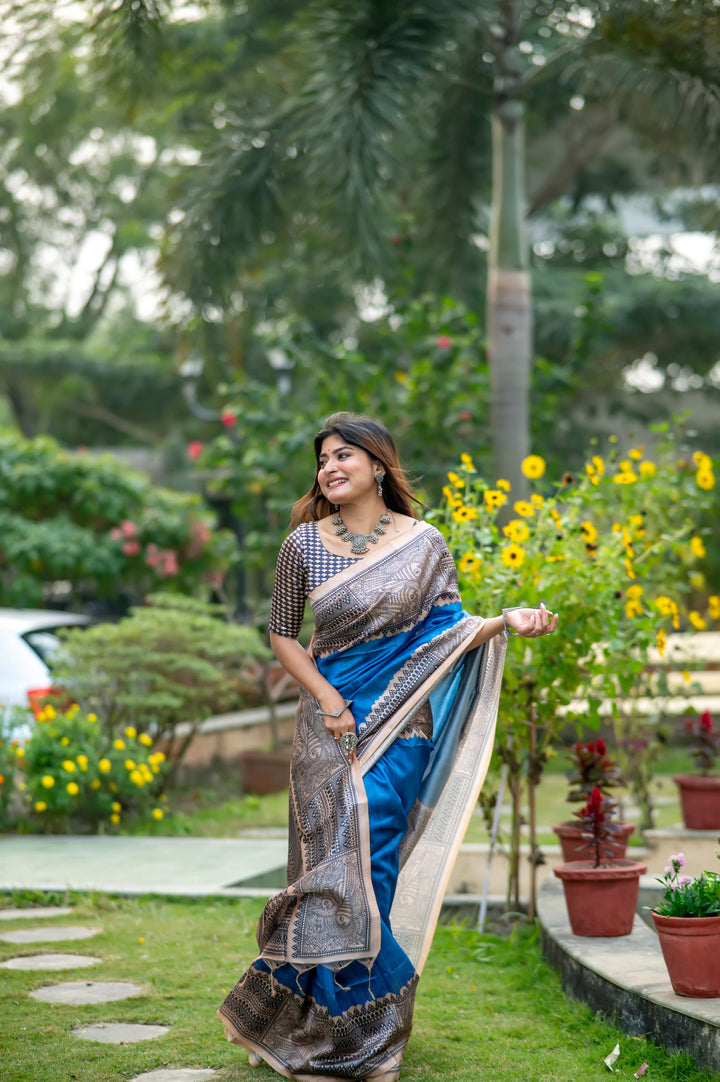 Stunning fiery orange soft tussar silk saree with beautiful Madhubani prints and stylish tassels, perfect for celebrations.