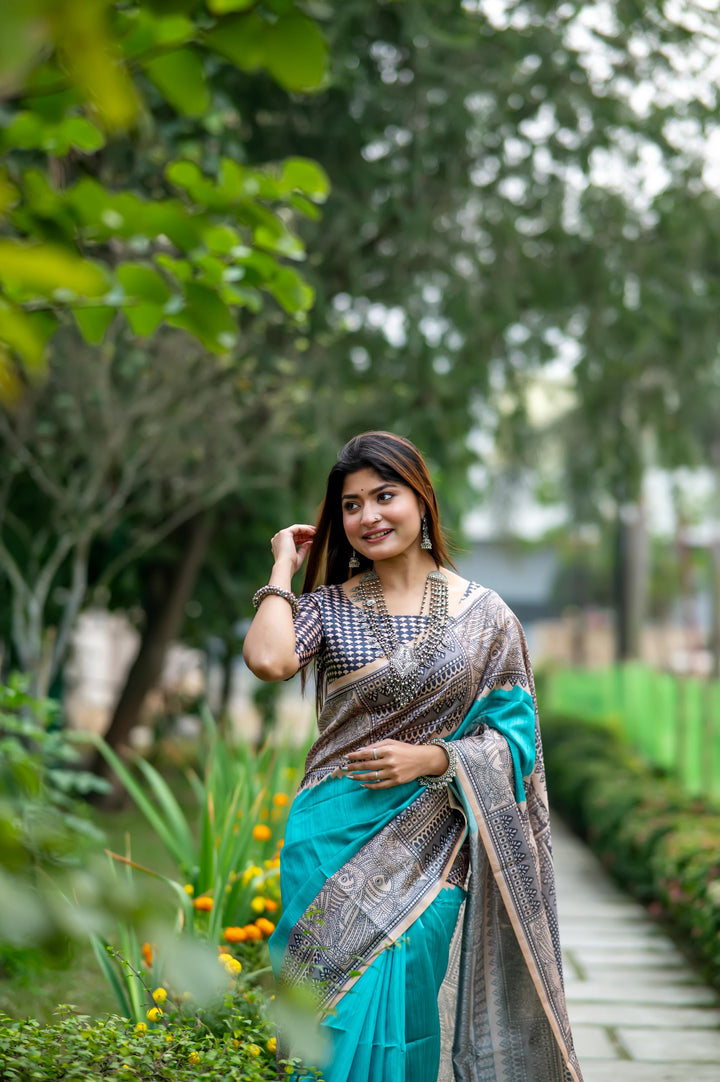 Stunning blue soft tussar silk saree with beautiful Madhubani prints and playful tassels, ideal for evening functions.