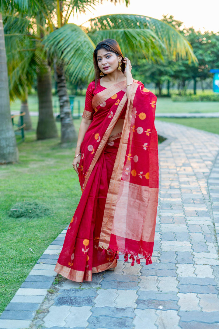 Elegant red pure linen silk saree with Jamdani border and brocade blouse, perfect for traditional occasions.