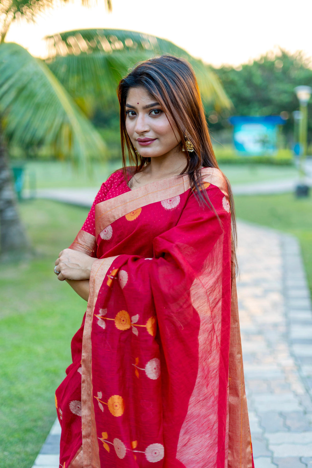 Bold red pure linen silk saree with a beautiful Jamdani border and luxurious brocade blouse, perfect for festivals.