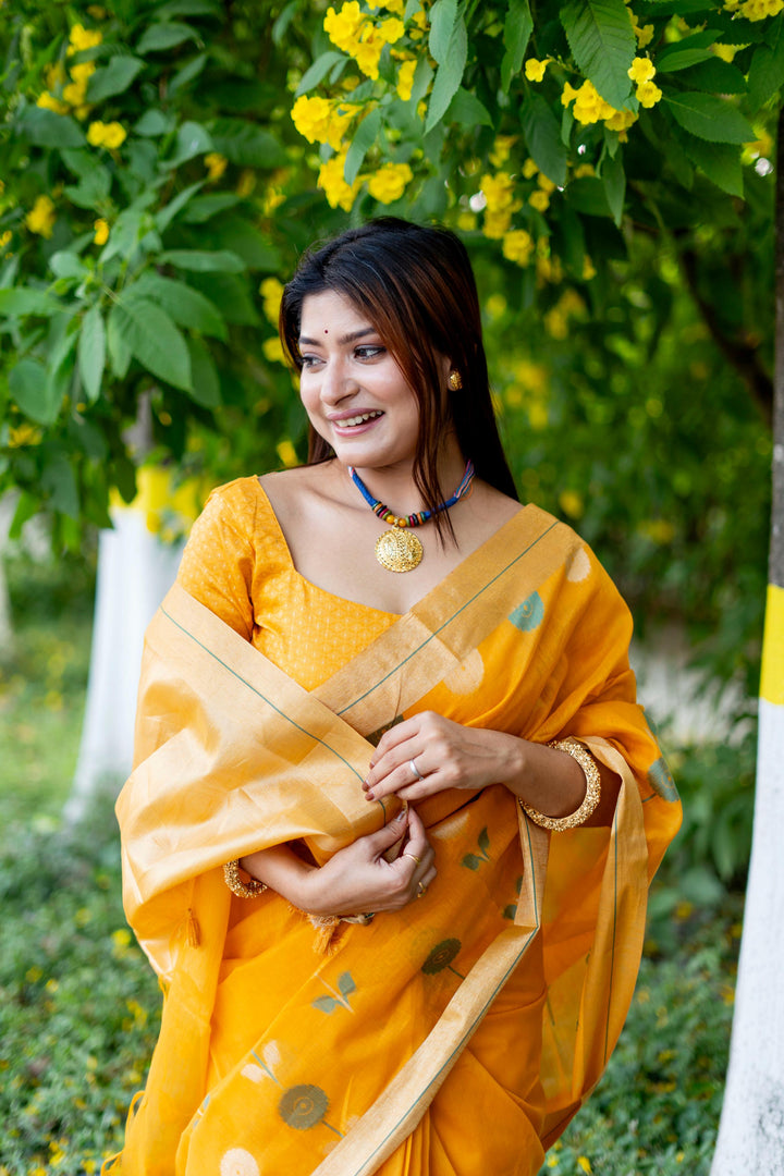 Bright yellow pure linen silk saree with intricate Jamdani border and elegant brocade blouse, ideal for weddings.